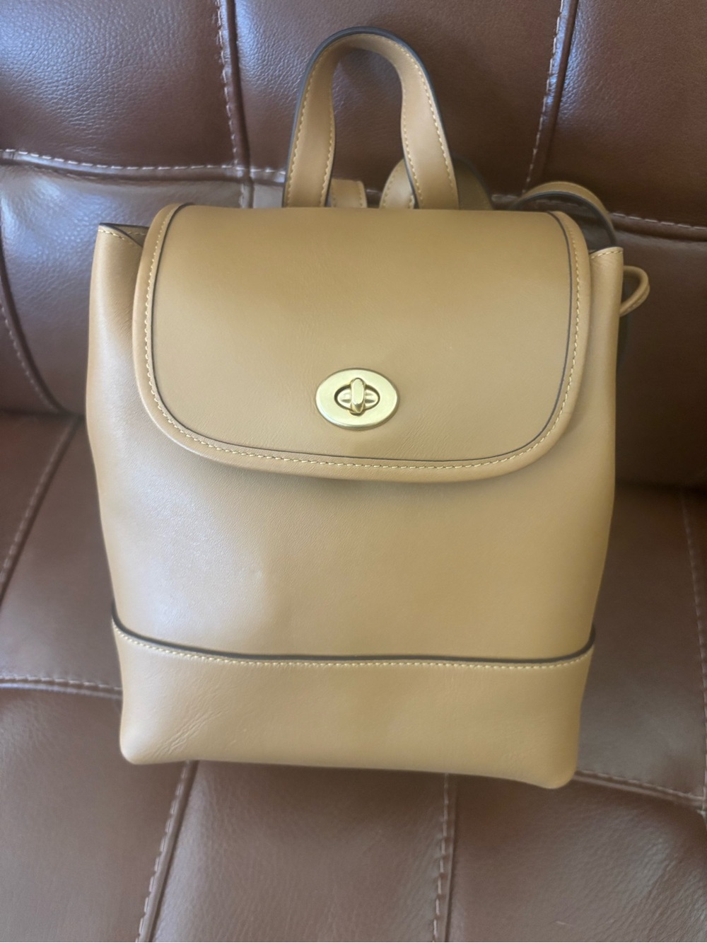 The Coach Originals Glovetanned Leather Turnlock Backpack in Honey Brown